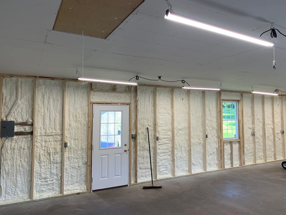 a garage with foam insulation on the walls and a door .