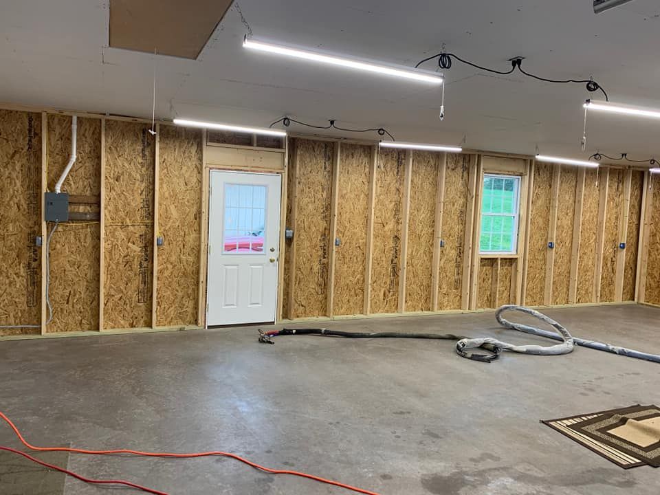 there is a vacuum cleaner in the middle of the garage .