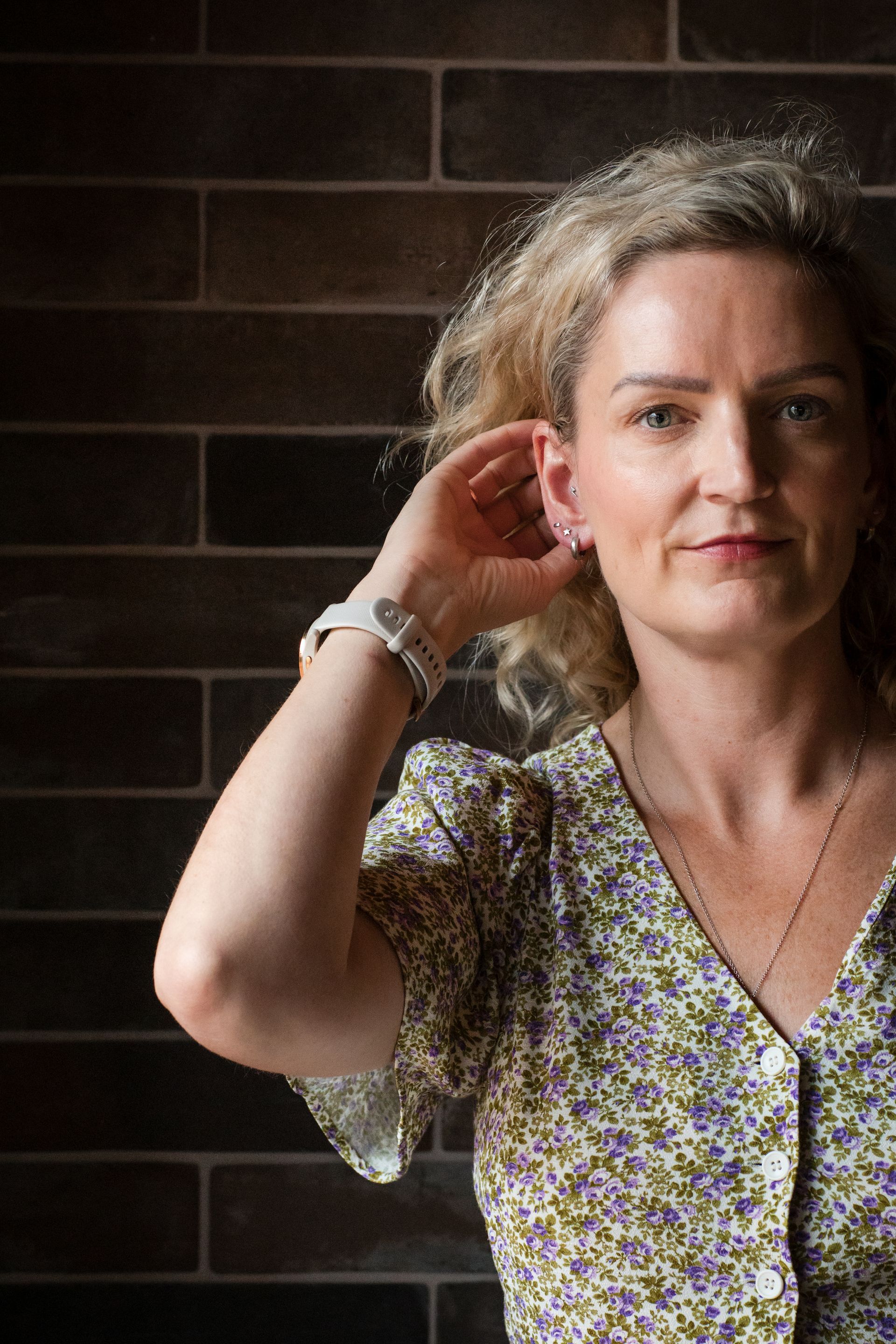 Nicola Theaker CEO of  VA Hub standing in front of a brick wall