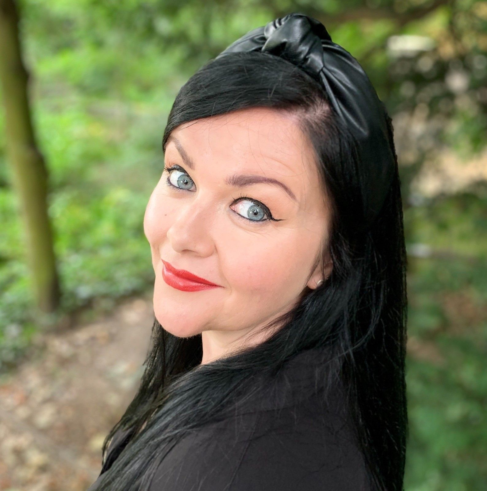 Image of Steph looking at the camera with trees in the back ground