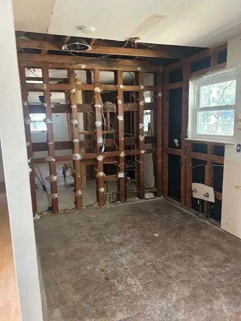 A room with a lot of wooden beams and a window.