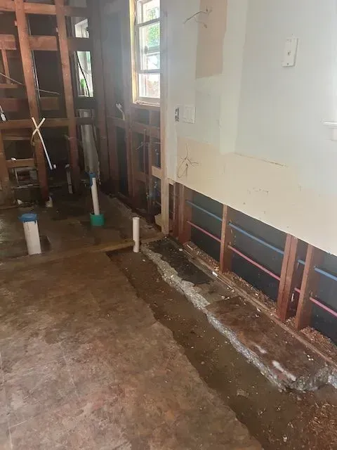 A room with a lot of wooden beams and a window.