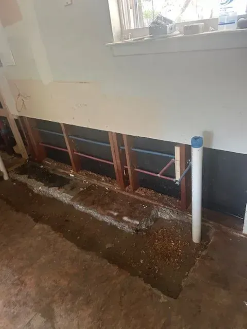 A room with a hole in the floor and a window.