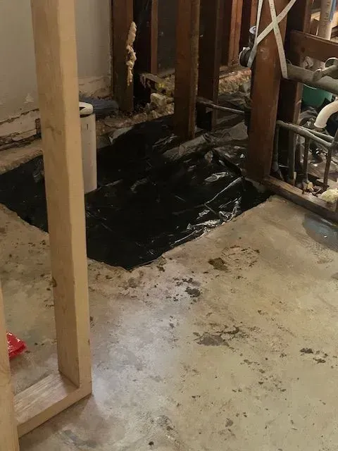 A bathroom under construction with a hole in the floor.