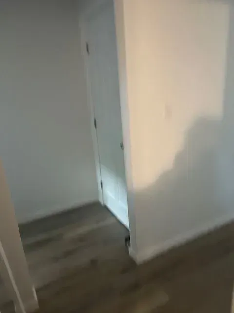 There is a shadow of a person on the wall in the hallway.