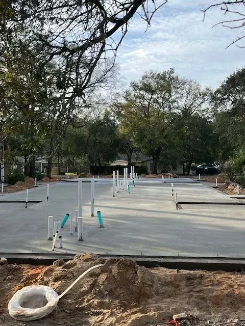 A concrete base for a house is being built.