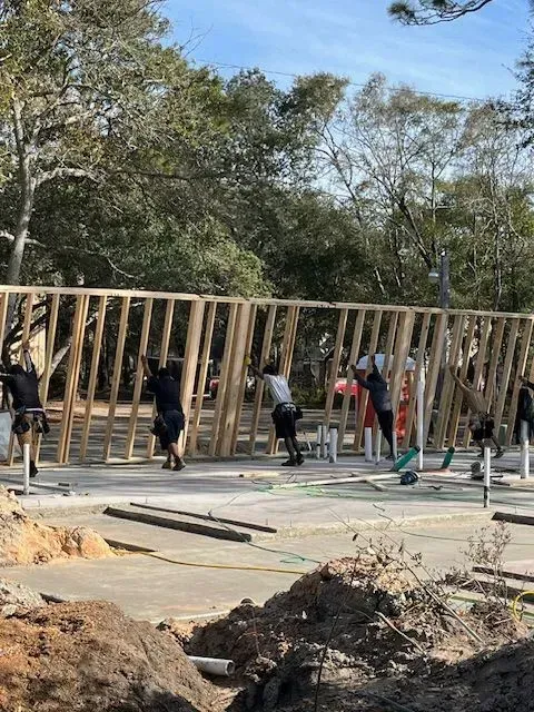 A group of construction workers are working on a building.