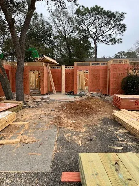 A house is being built in a backyard with a lot of wood.