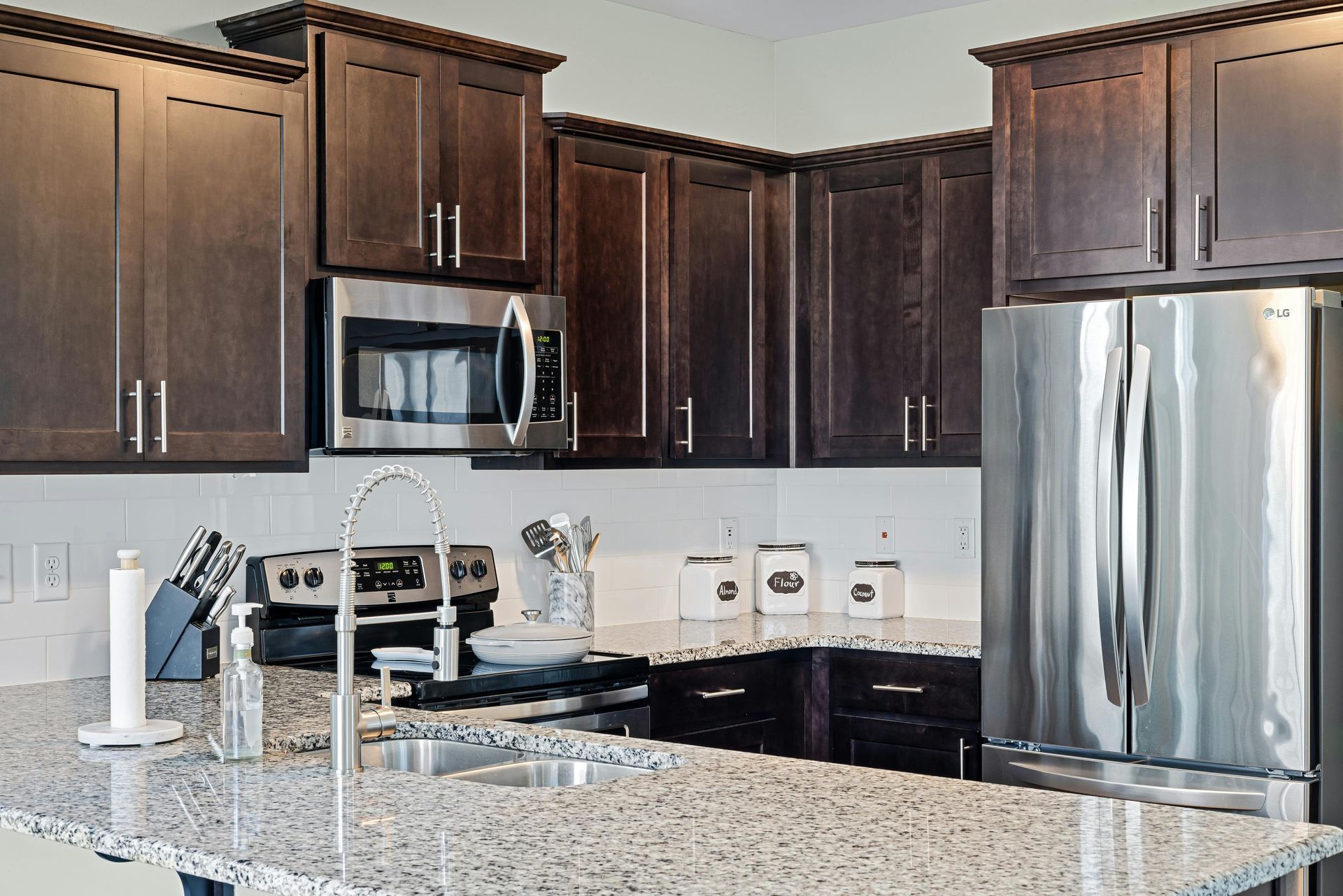 A kitchen with granite counter tops and stainless steel appliances