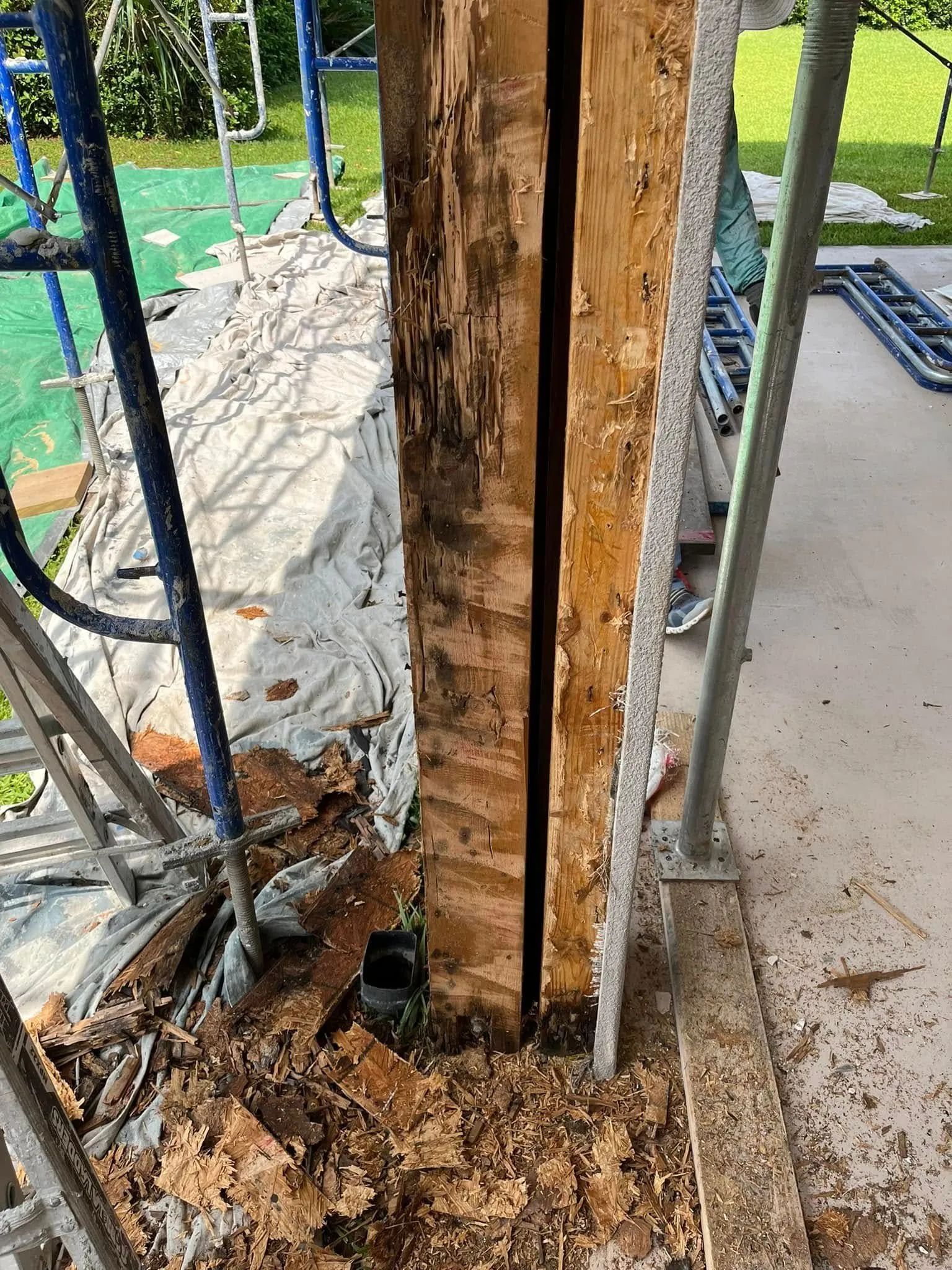 A wooden post is being removed from a building.
