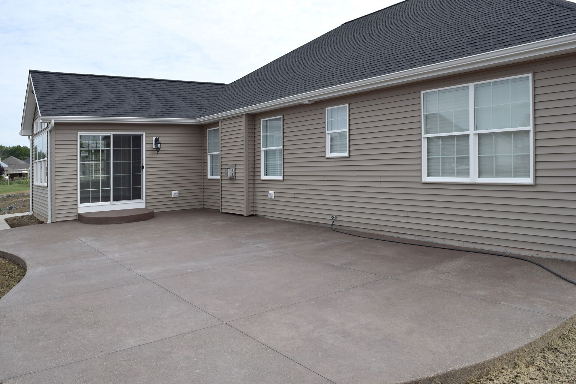 A house with a concrete patio in front of it