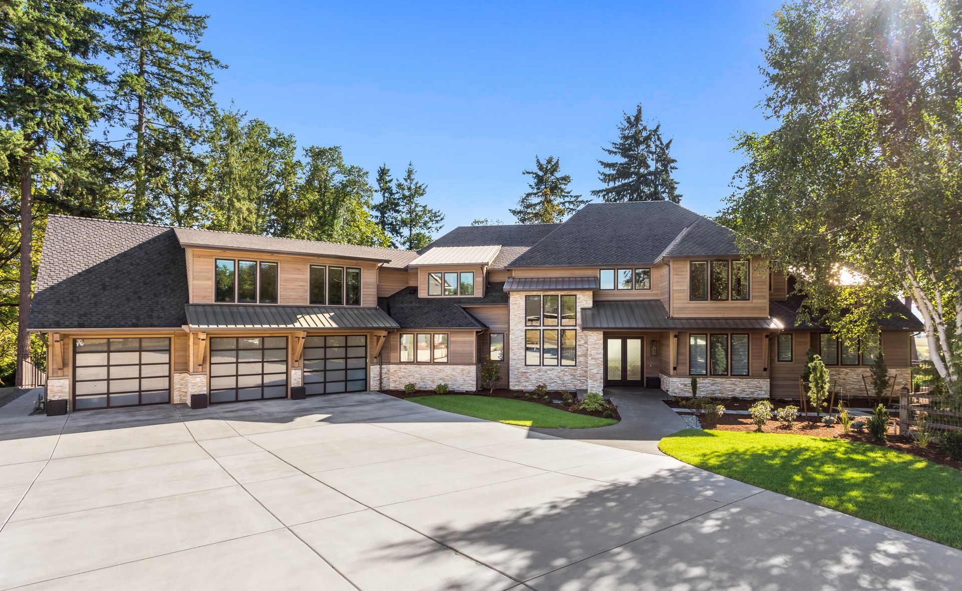 A large house with a lot of windows is surrounded by trees.