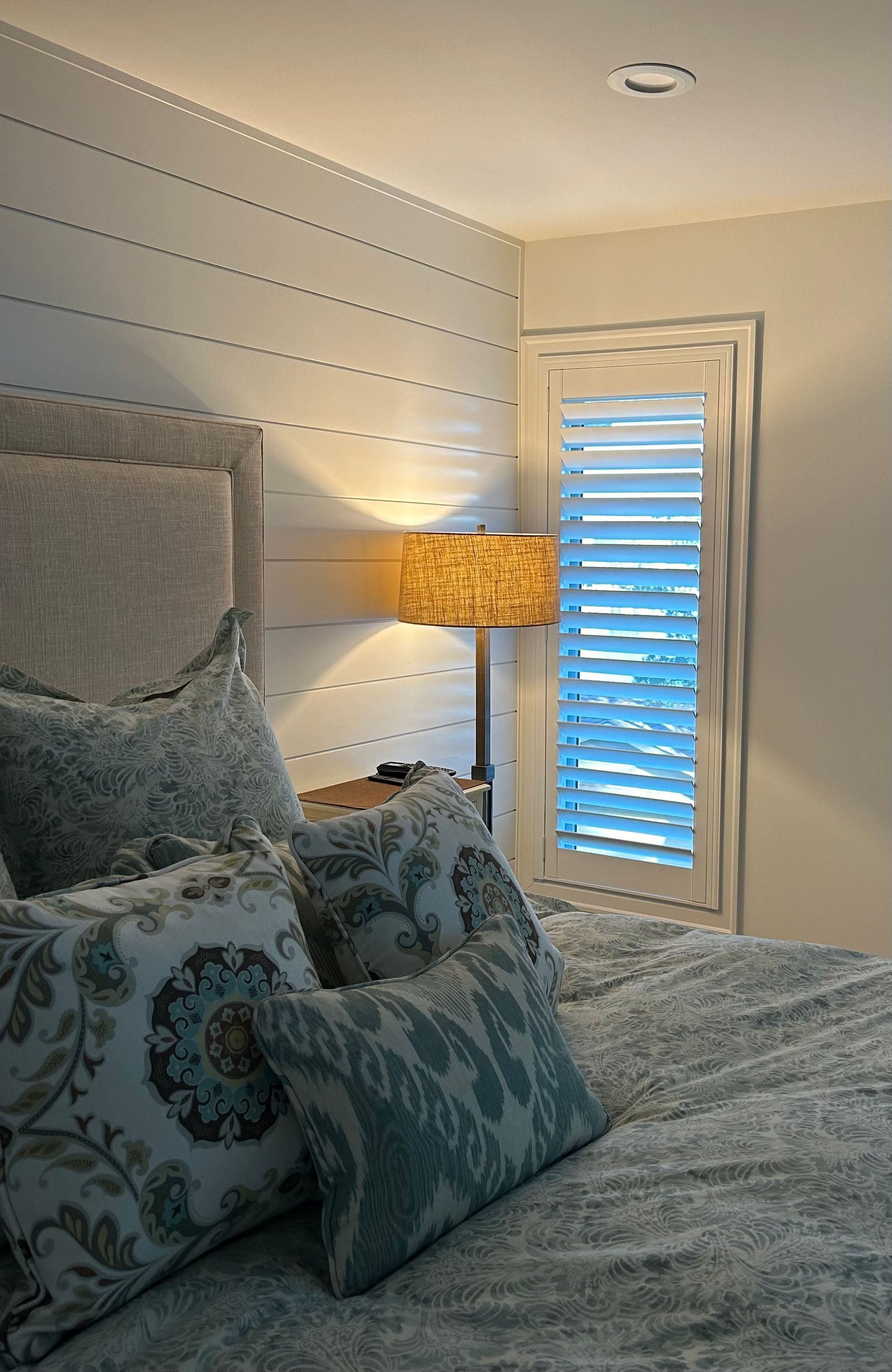 Bedroom shutters with custom bedding
