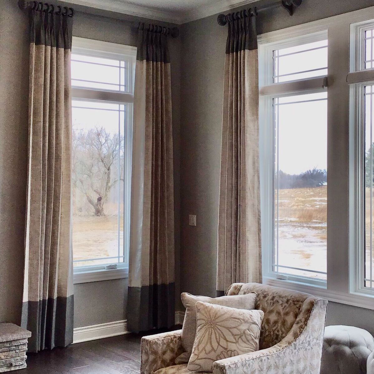 A bedroom with a bed a lamp and a window with shutters