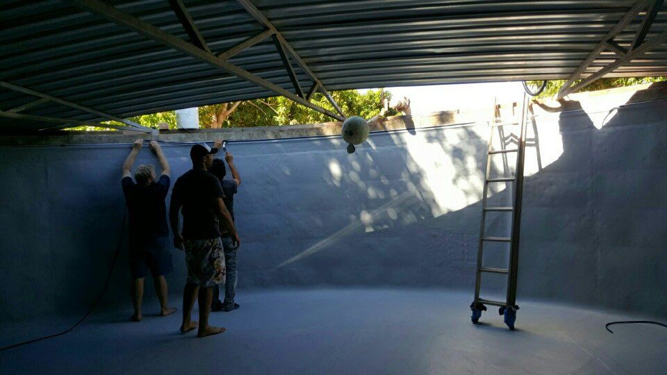 people installing liner in water tank