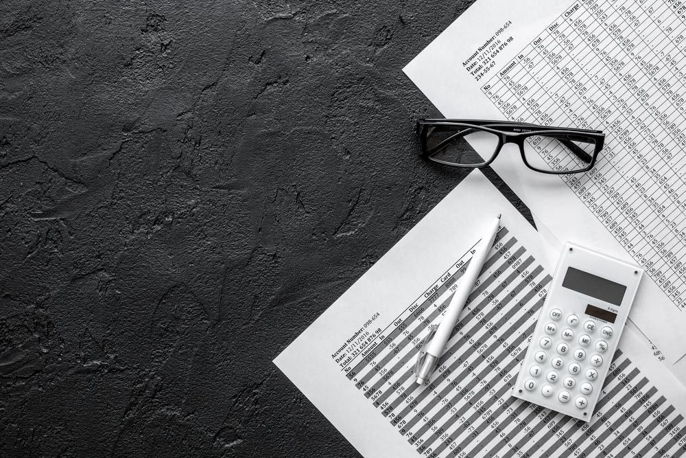 A Pair Of Glasses , A Pen , A Calculator , And Some Papers On A Table — NQ Business Advisers In Jensen, QLD