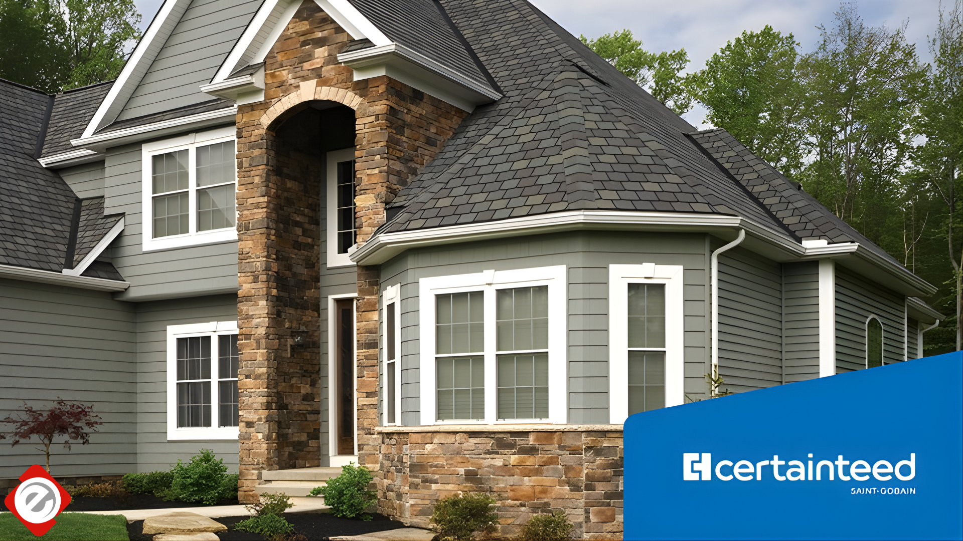 Gray house with stone accents, white trim, and black roof.