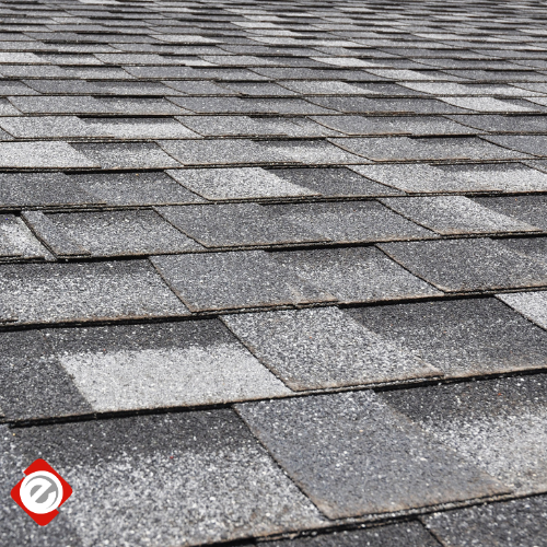 Close-up view of a gray and black asphalt shingle roof.