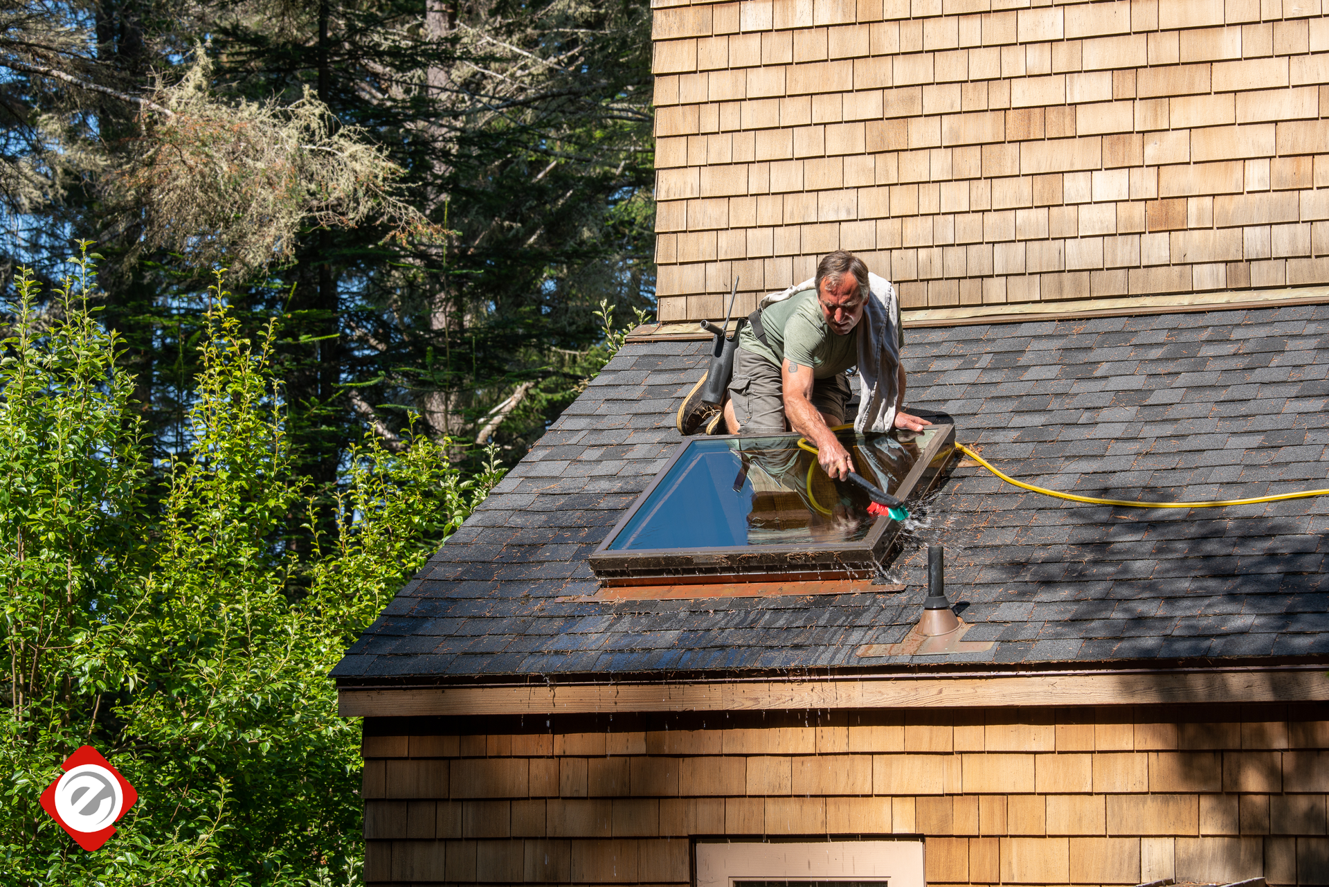A man is working on the roof of a house.