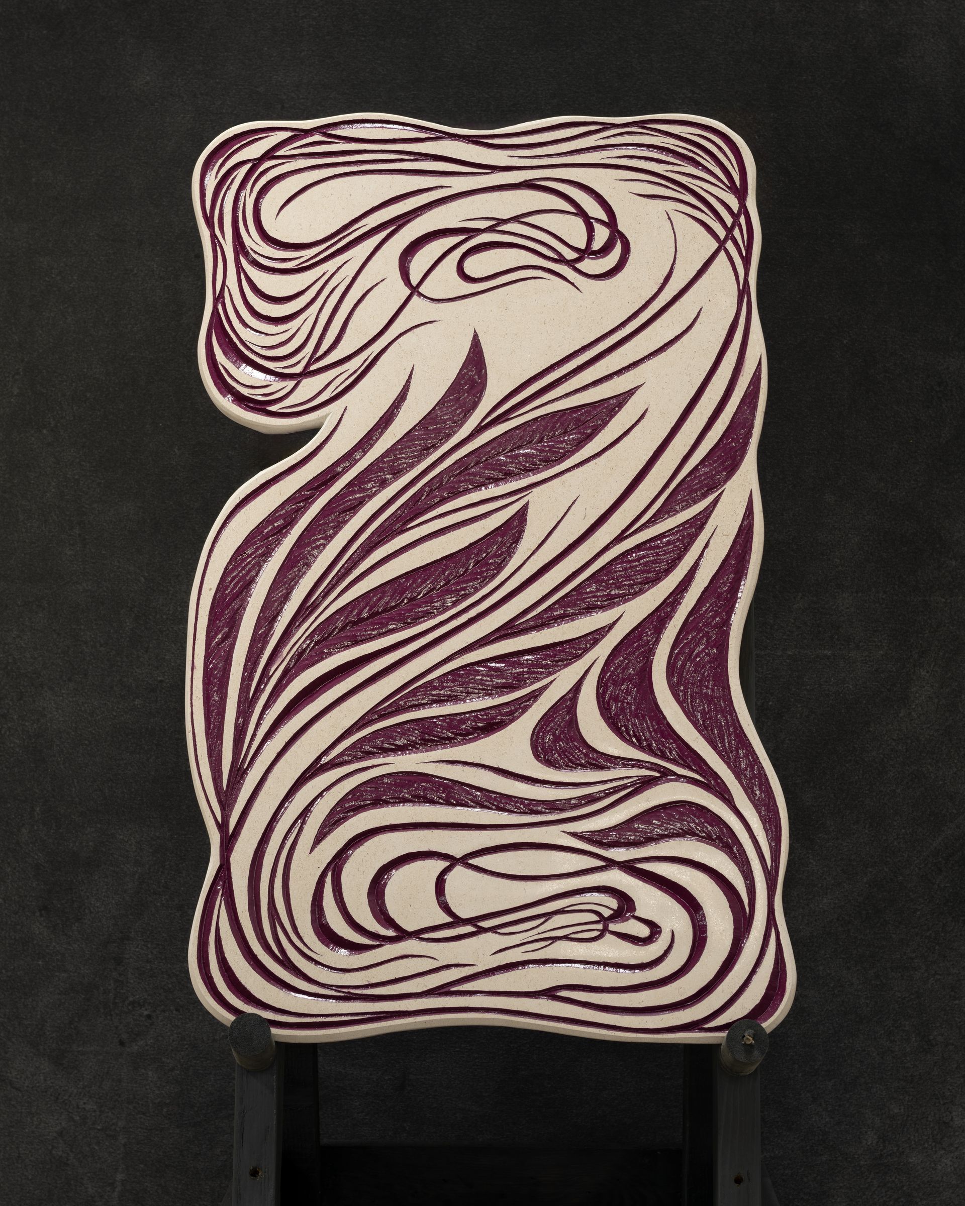 A purple and white swirl on a black surface