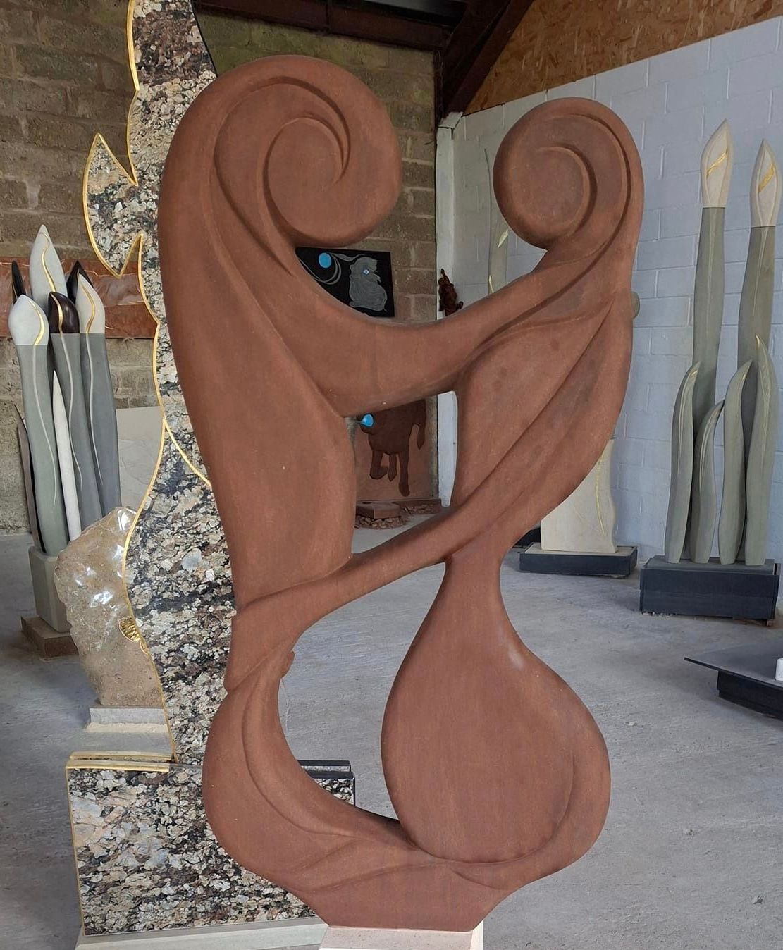 A sculpture in a room with other sculptures