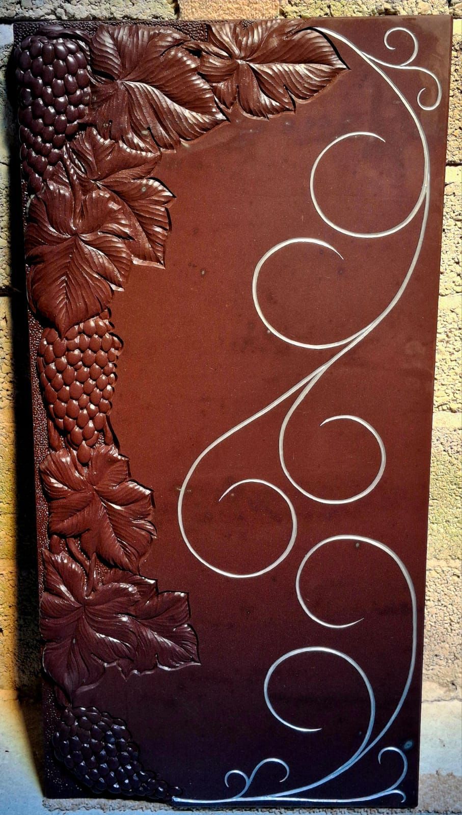 A brown book with leaves and grapes on it