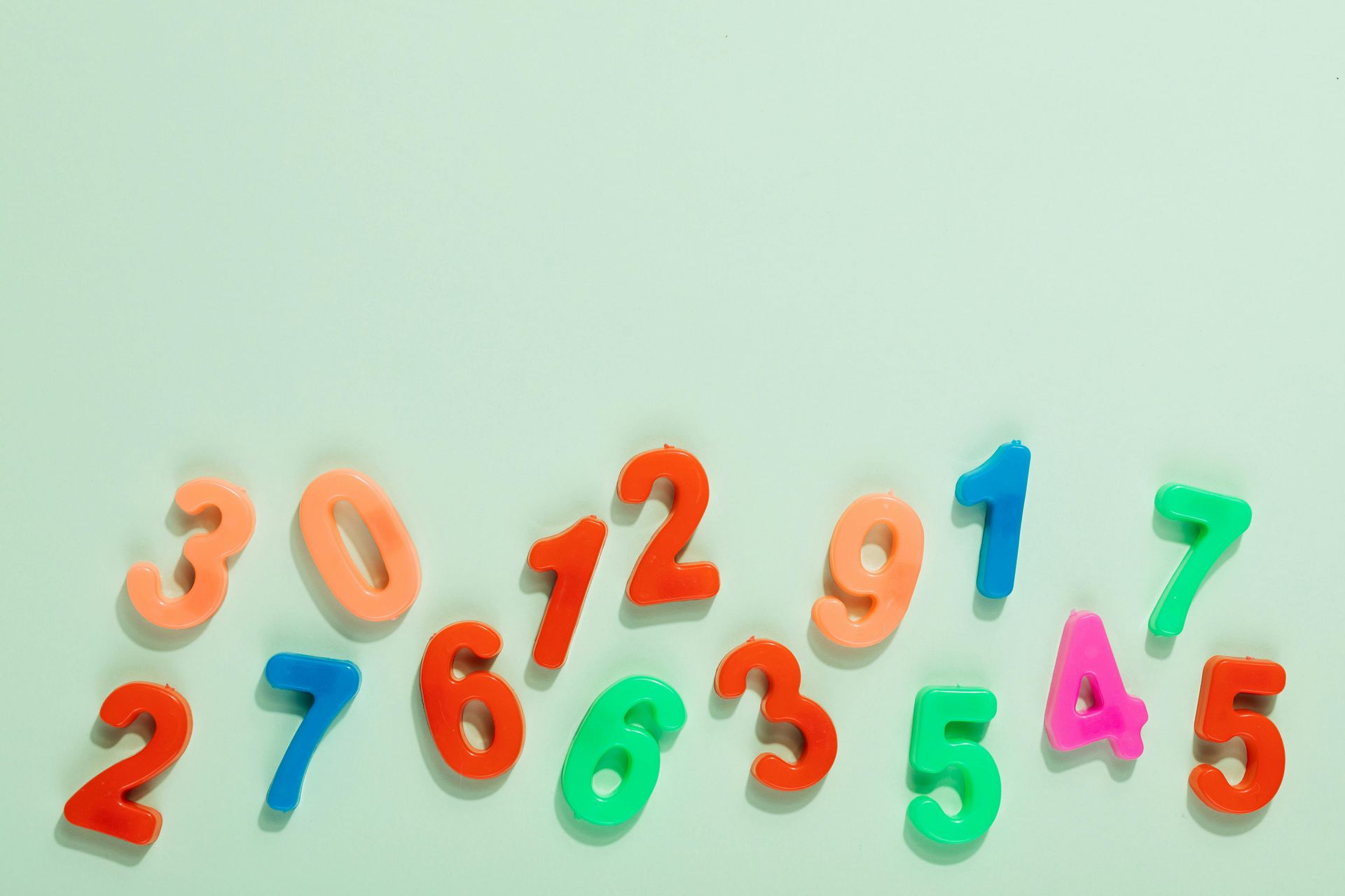 Magnet numbers of all colors together on a light green background