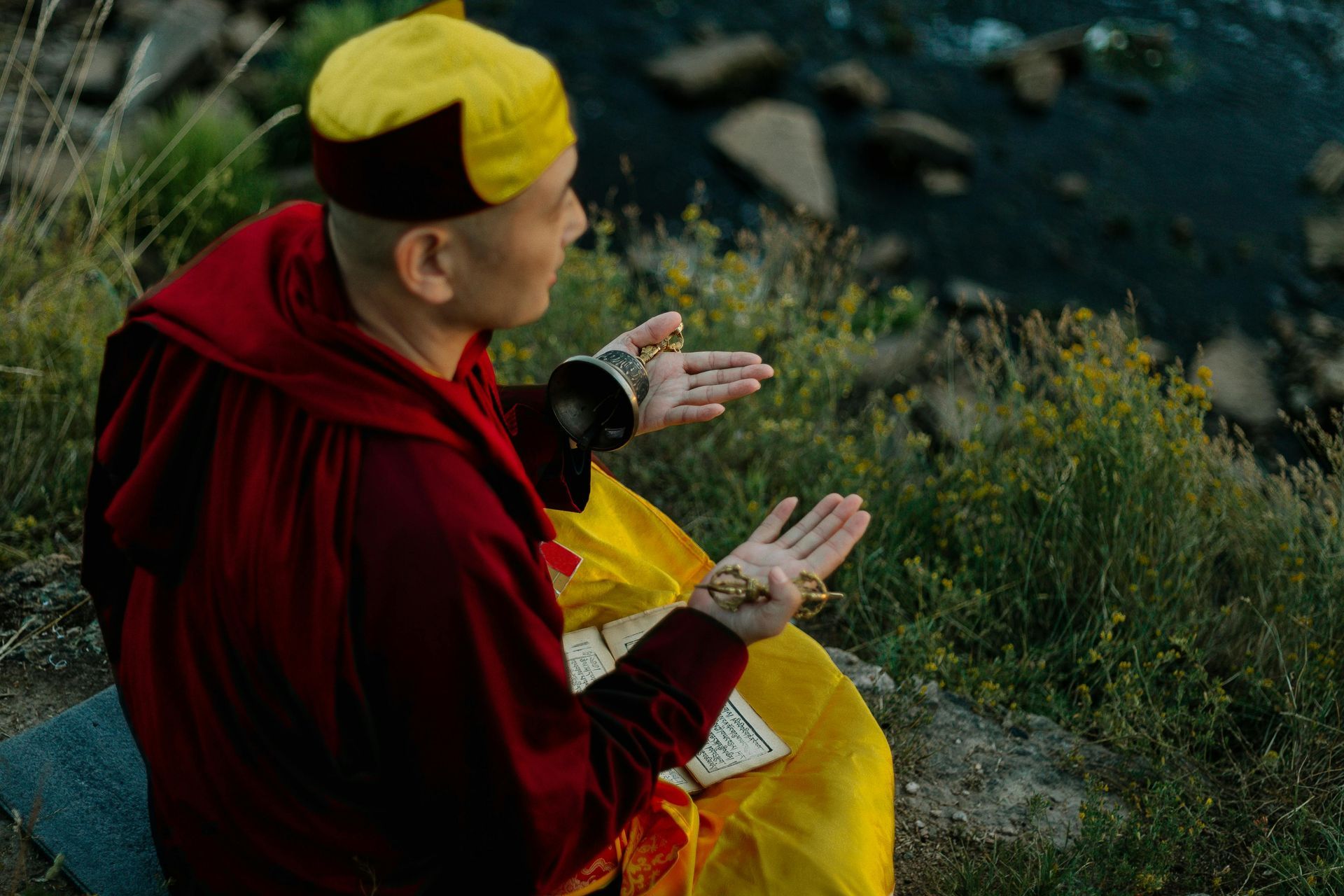 man with a yellow hat praying
