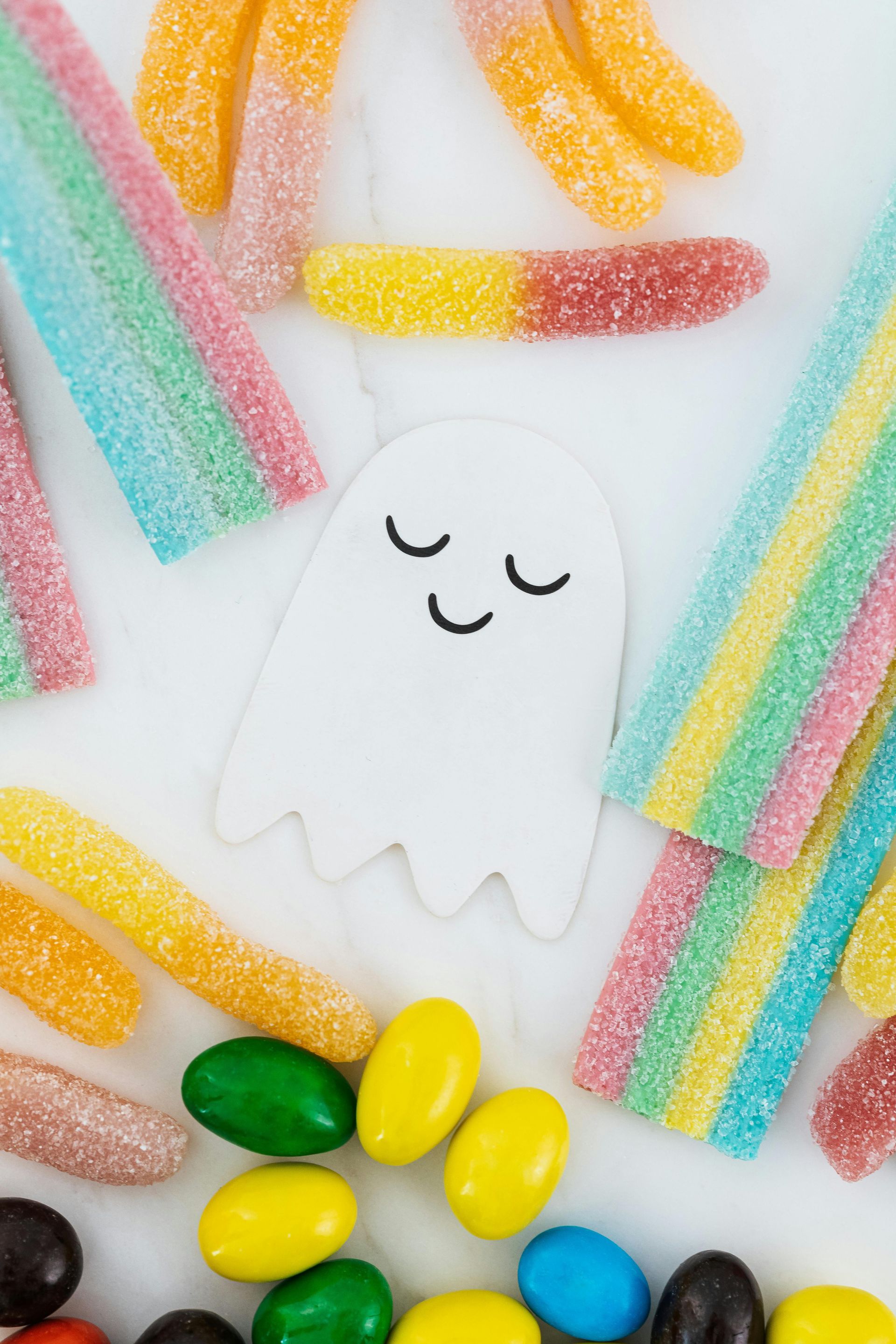 smiling ghost next to candy 