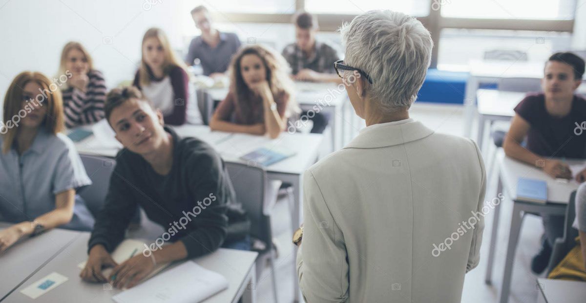 a teacher is giving a lecture to a group of students in a classroom .