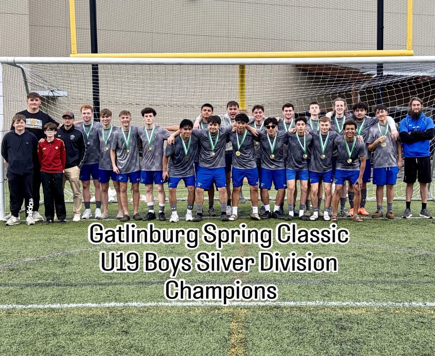 Soccer field corner with a yellow flag and a white ball.