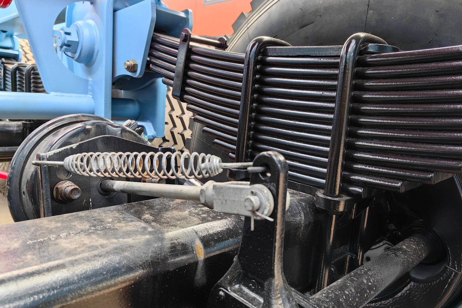 A close up of a leaf spring on a tractor.