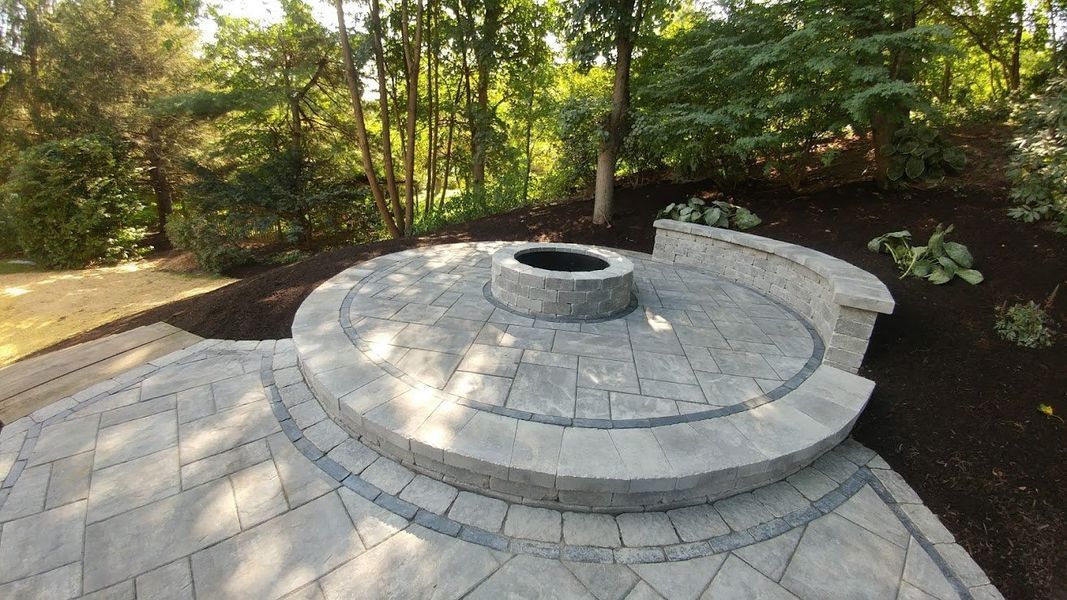 There is a fire pit in the middle of the patio.