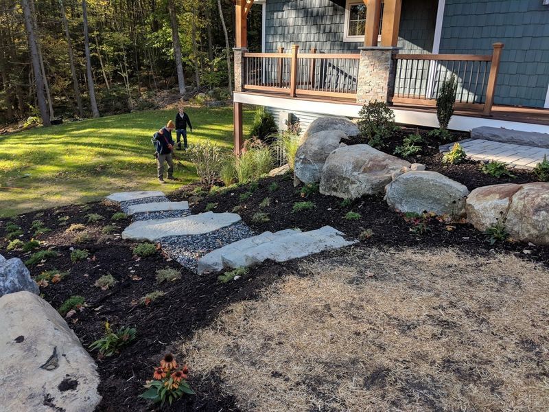 A couple of people are standing in front of a house.