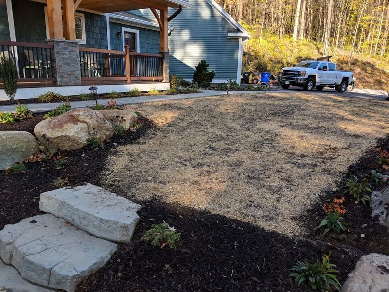 A white truck is parked in front of a house.