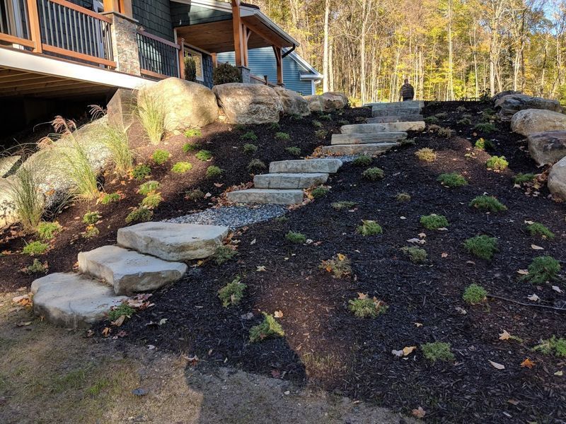 A set of stairs leading up to a house on a hill.