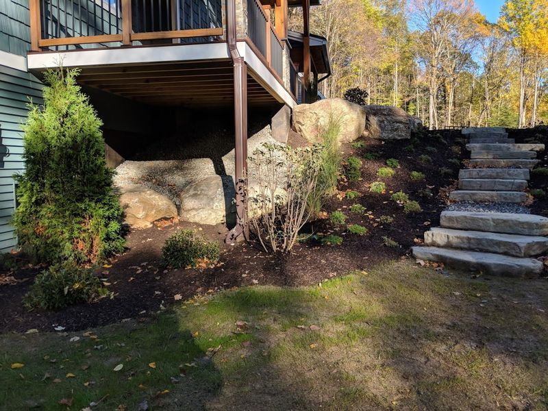 A house with a deck and stairs in the backyard.