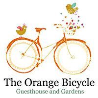 Orange bicycle logo with bird and fruit, reading &ldquo;The Orange Bicycle Guesthouse and Gardens&rdquo;