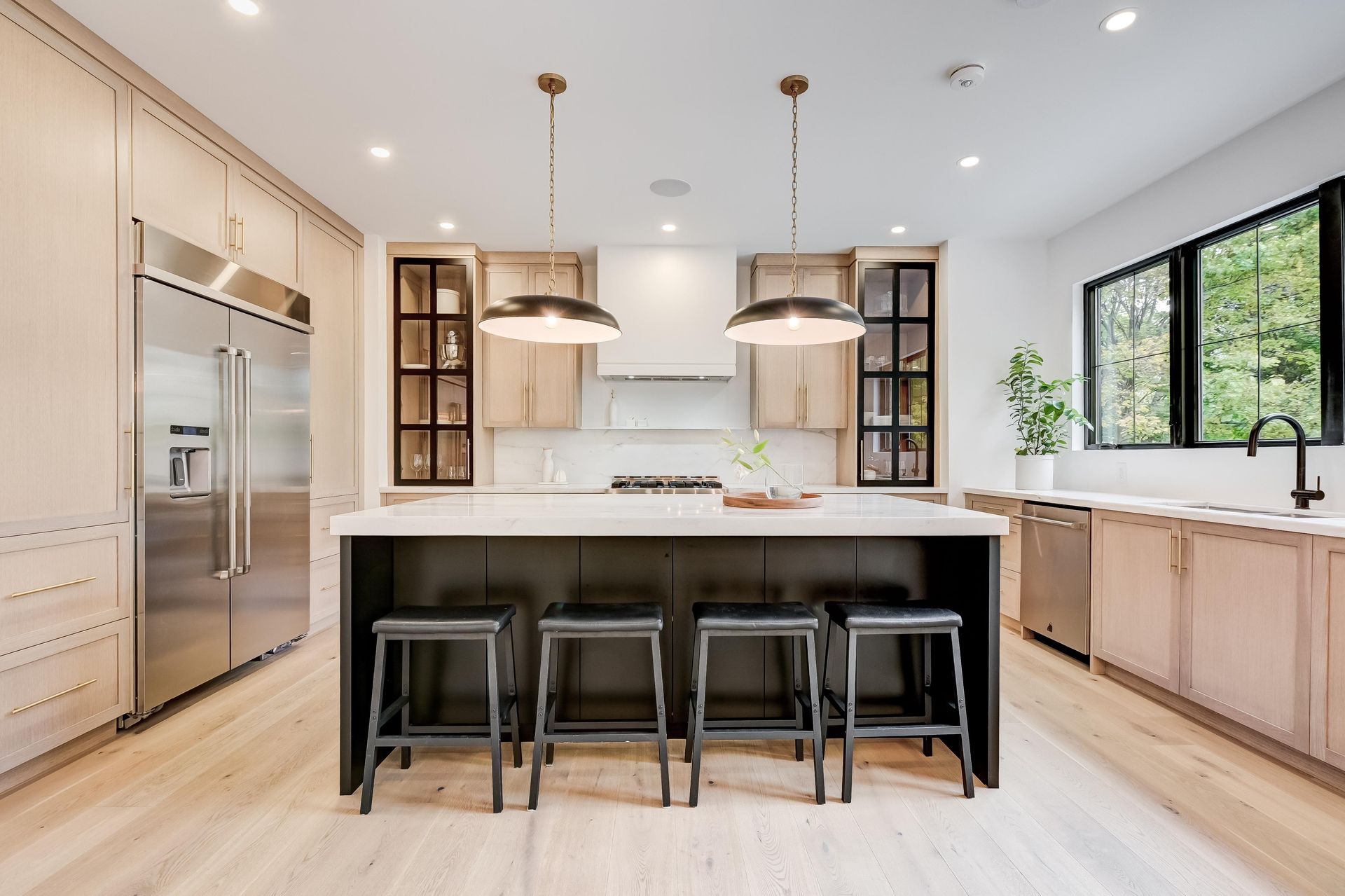 A kitchen with a large island and stools