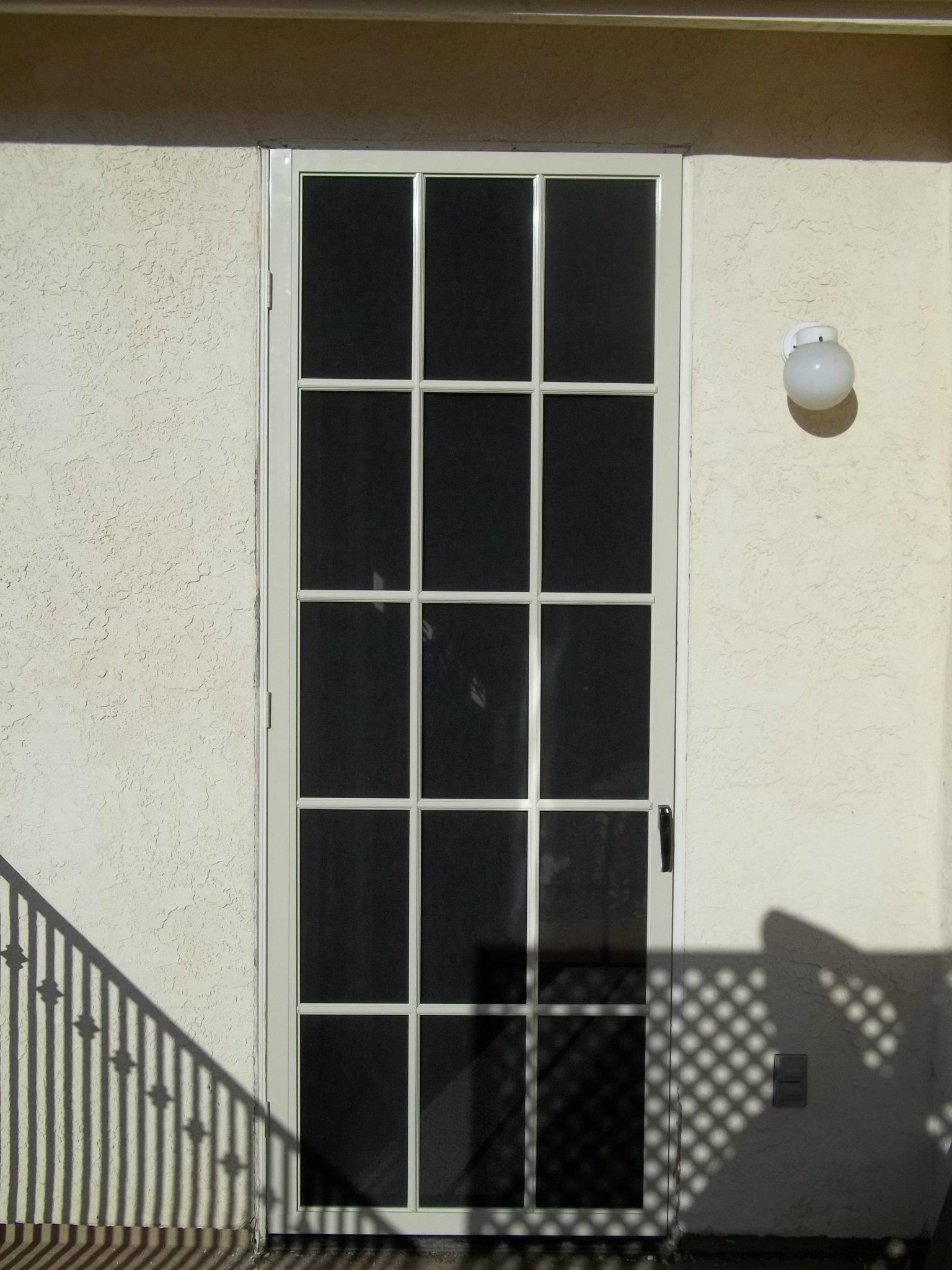 A white door with a black screen on it