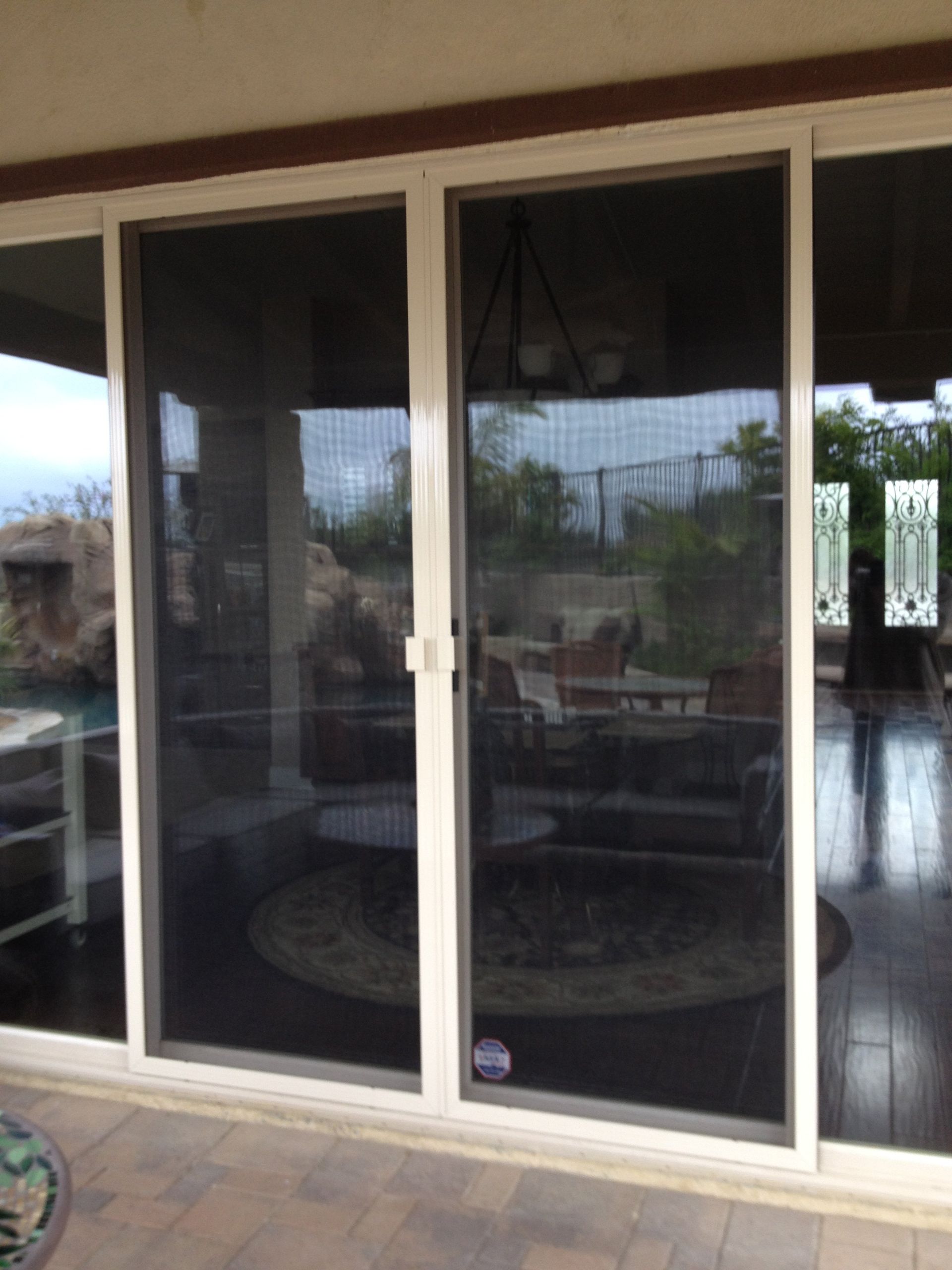 A patio with sliding glass doors leading to a living room