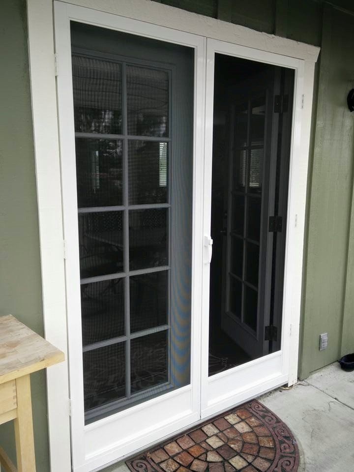 A white sliding glass door is open to a patio.