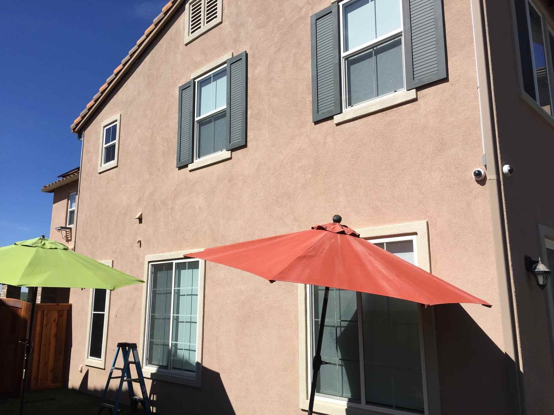 A house with a red umbrella in front of it