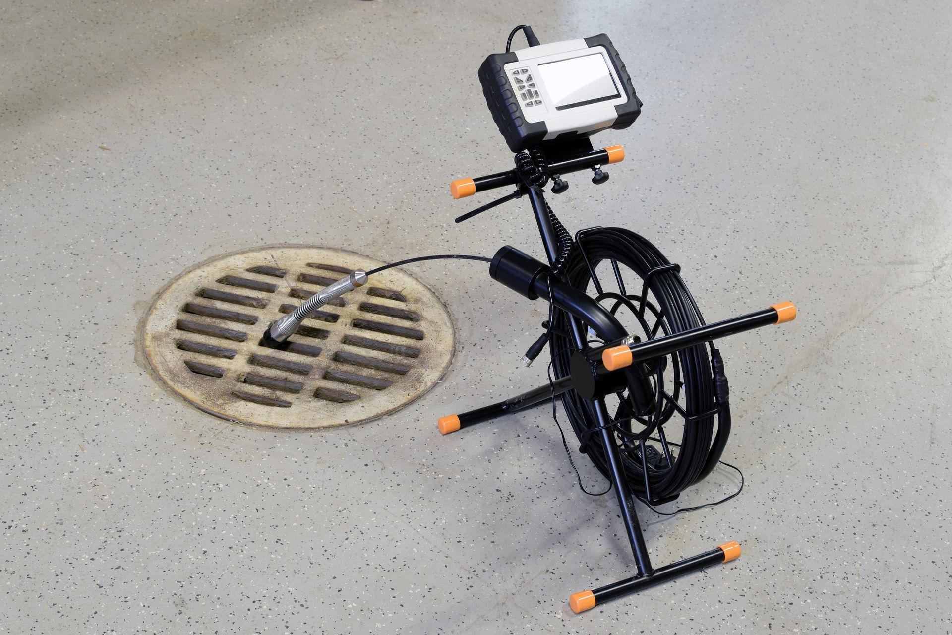 a drain with a camera attached to it and a remote control