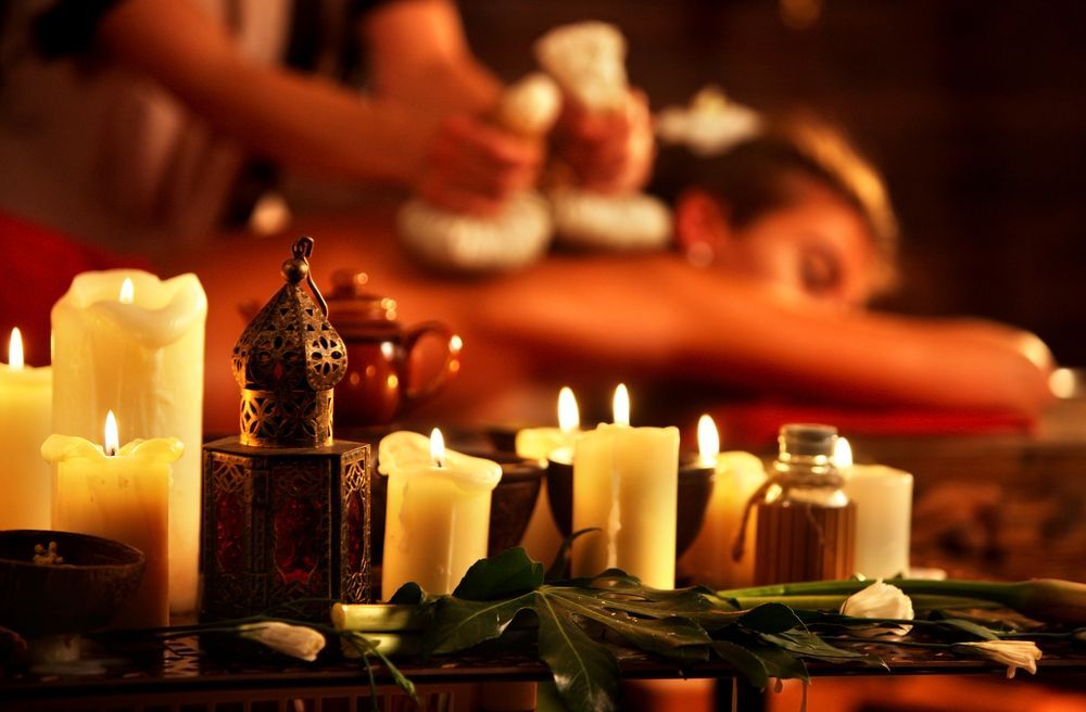 Spa Massage With Lit Candles, Herbal Compress on Back — Leela Thai Massage & Spa in Newtown, QLD