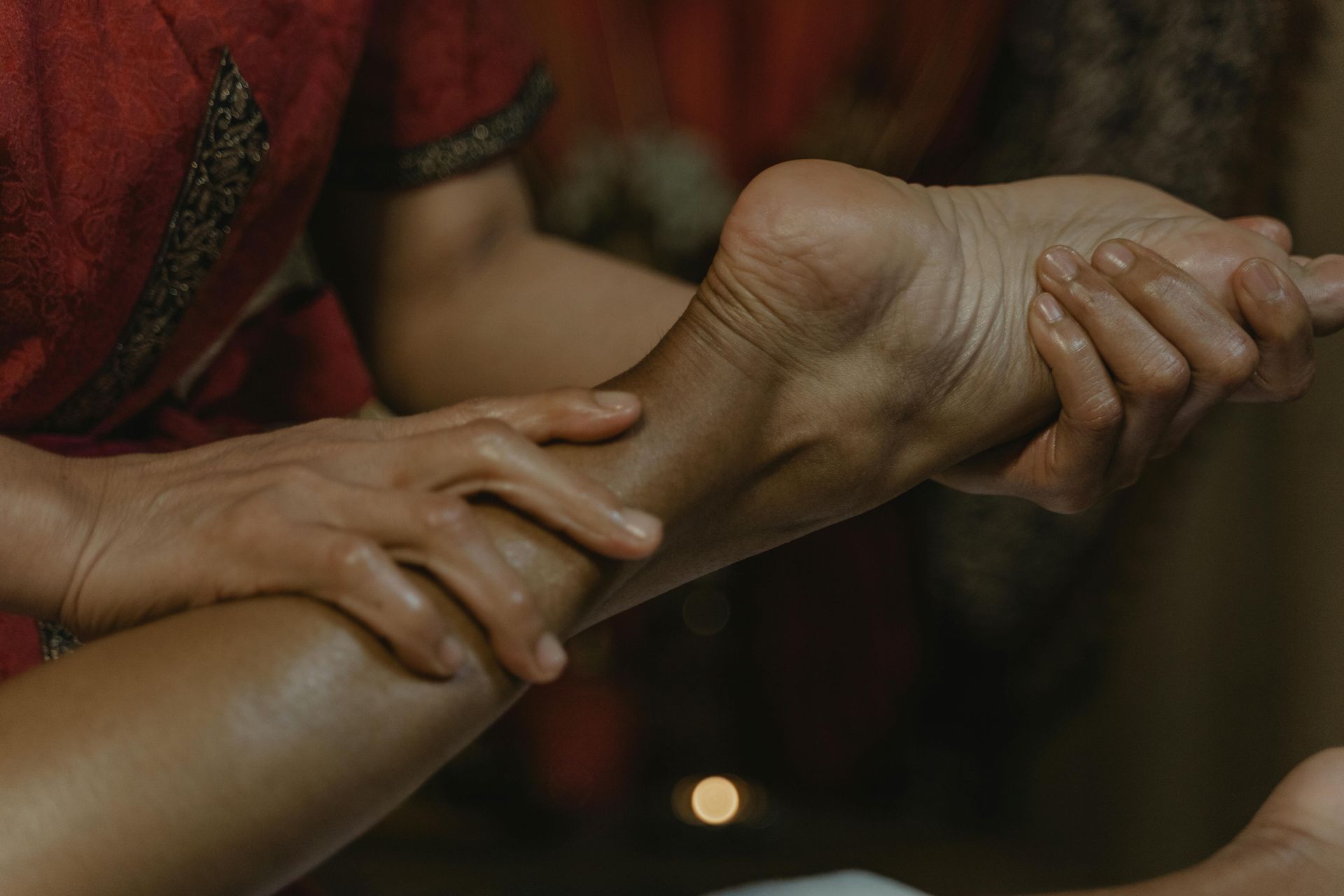 Hands Massaging a Foot and Ankle With Oil — Leela Thai Massage & Spa in Newtown, QLD