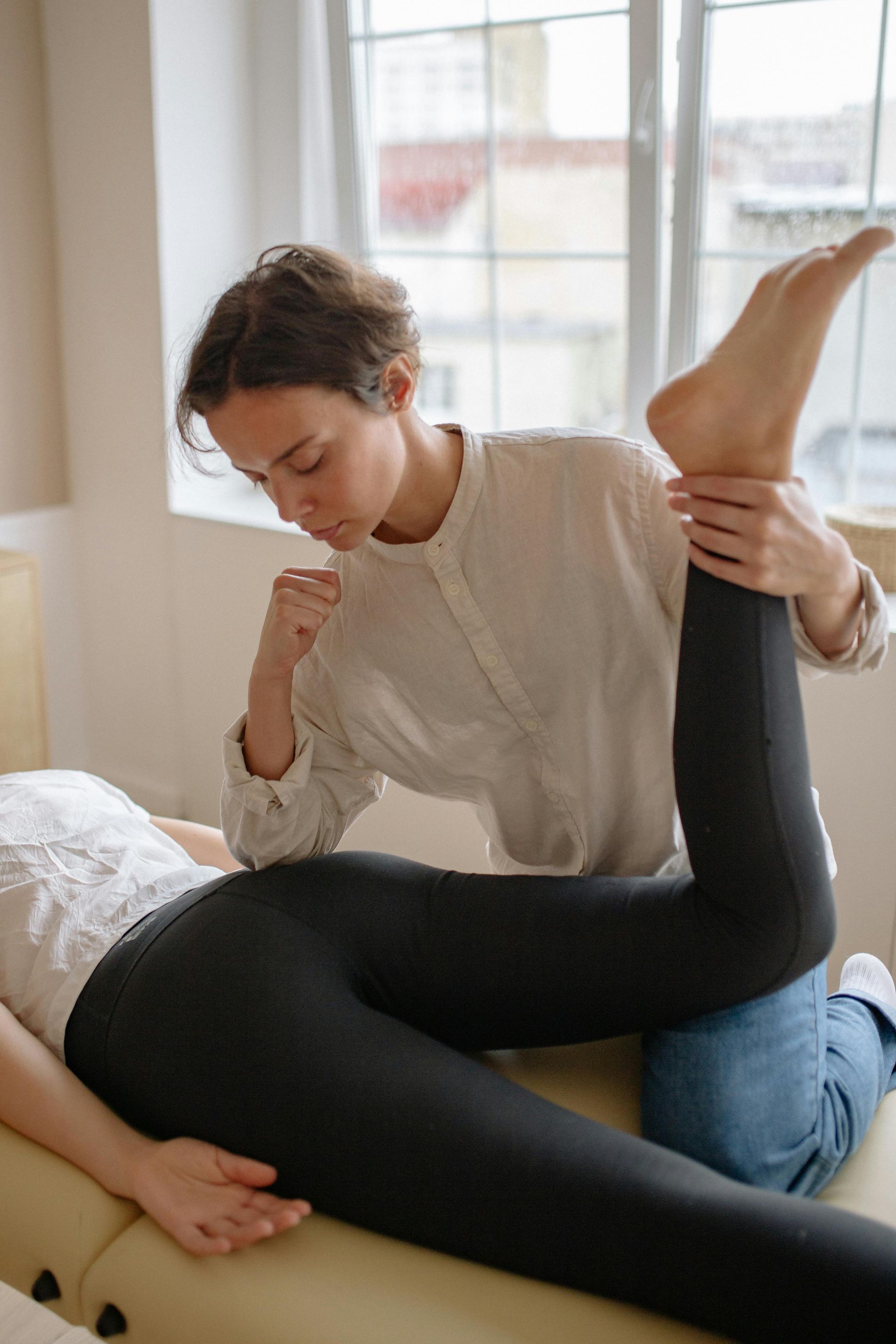 Therapist Stretching a Person's Leg — Leela Thai Massage & Spa in Newtown, QLD