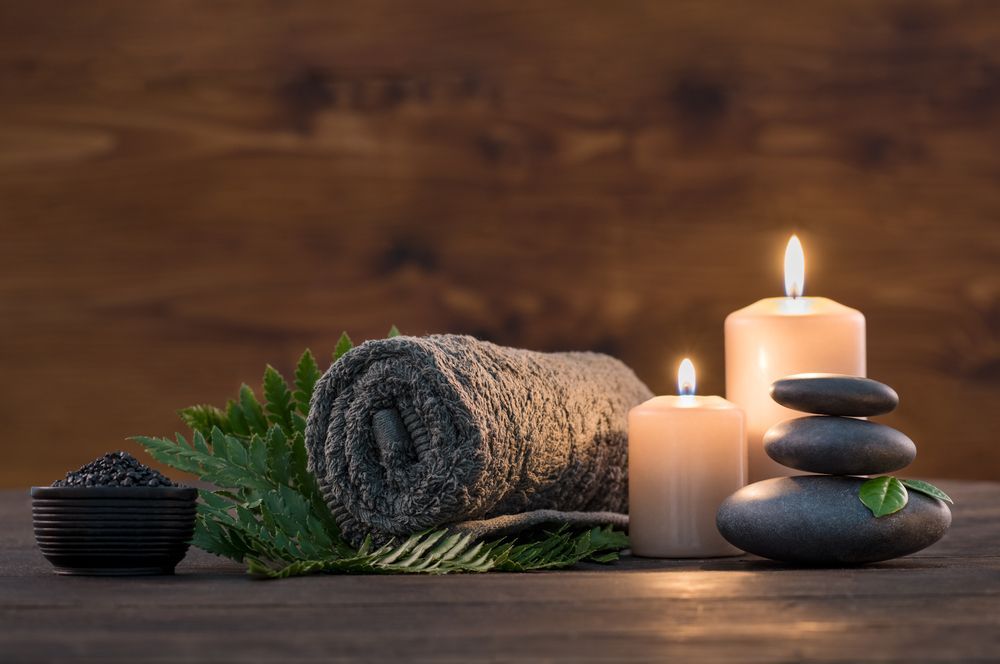 Candles, Stacked Stones and Rolled Towel — Leela Thai Massage & Spa in Newtown, QLD