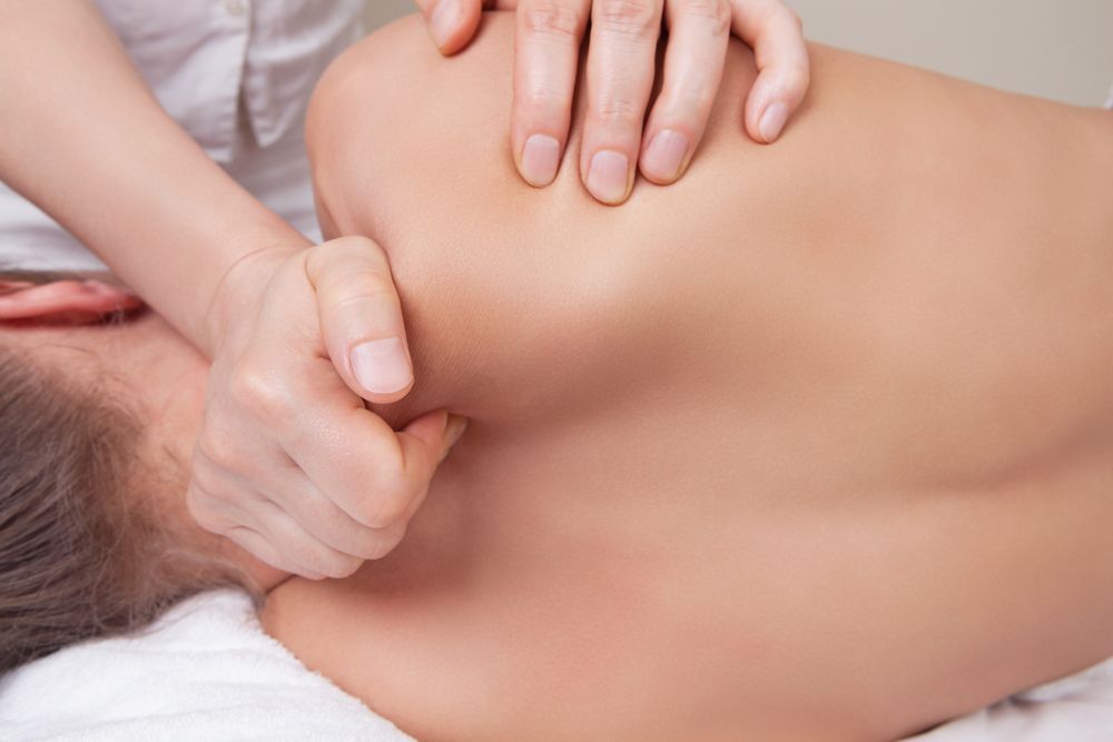 Hands Massaging a Shoulder — Leela Thai Massage & Spa in Newtown, QLD