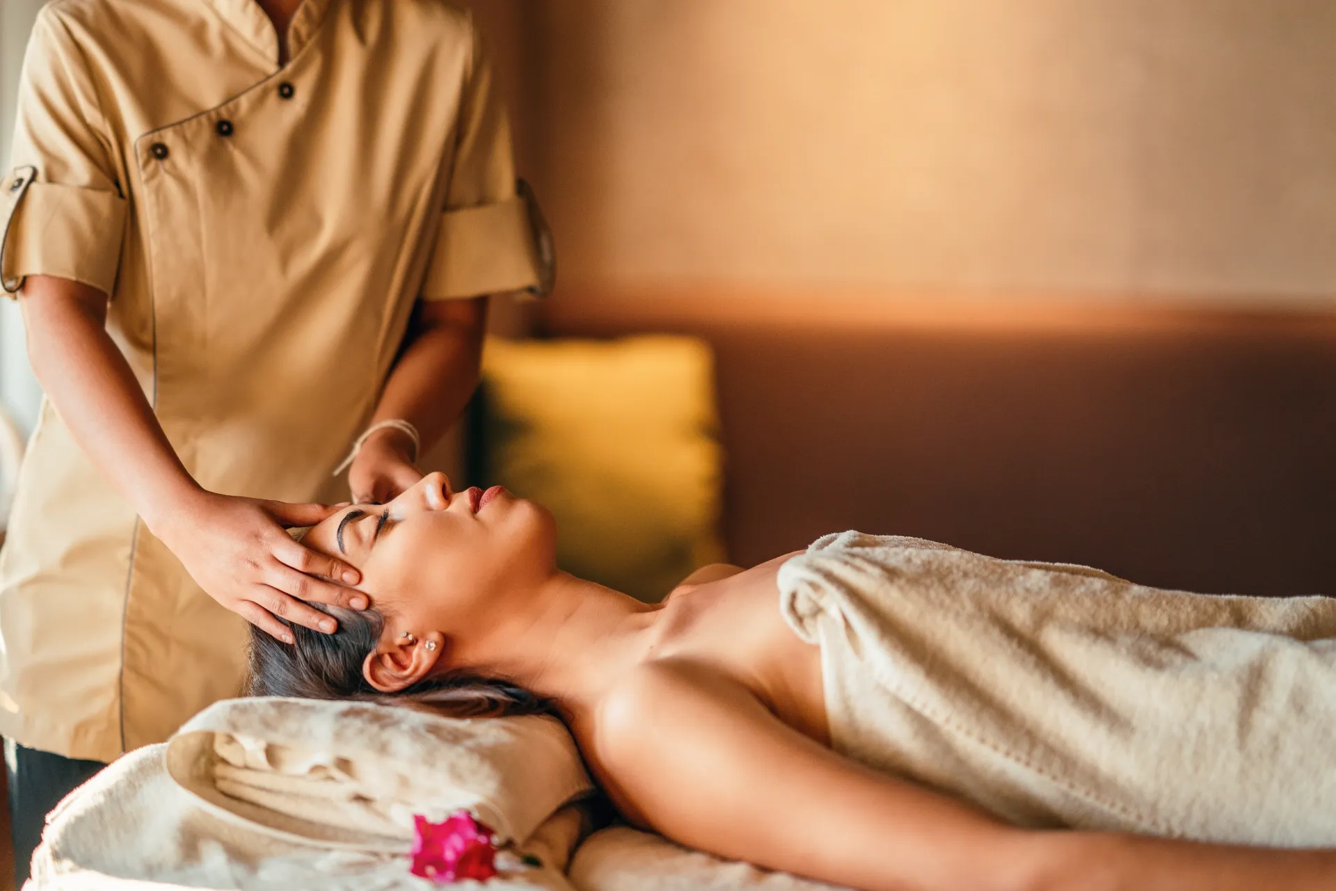 Hands Giving a Massage on a Bare Back in a Light Setting — Leela Thai Massage & Spa in Newtown, QLD